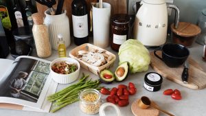 A variety of fresh ingredients and kitchen tools for preparing a healthy meal.